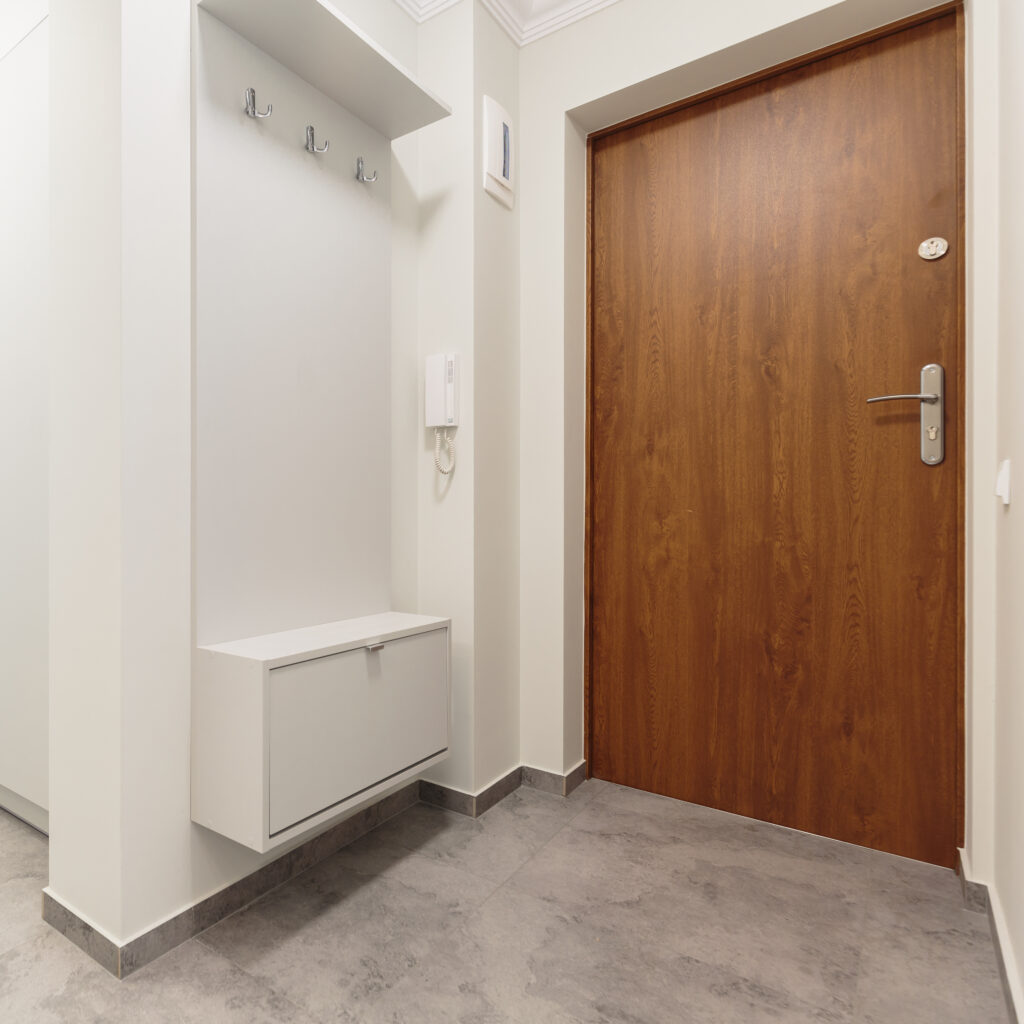 white-empty-anteroom-with-wooden-front-door-2025-10-02-03-04-12-utc